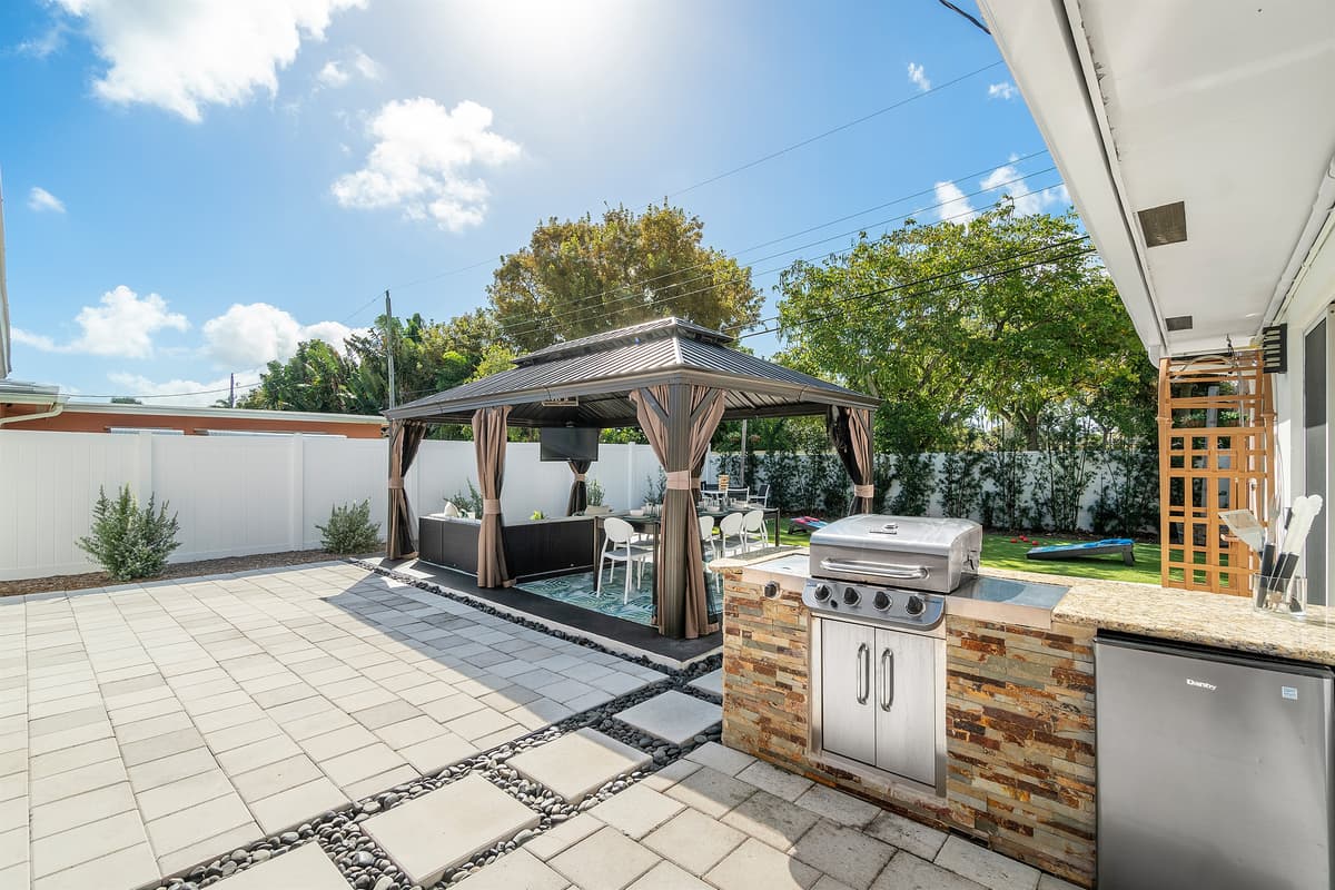 Custom built-in grill with a burner, and an outdoor fridge for your favorite cold beverages!