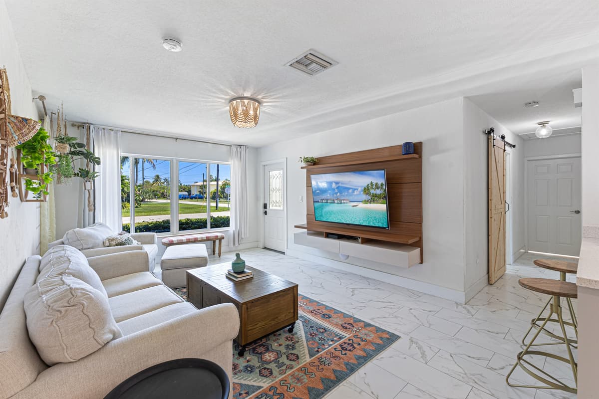 Bright, open living room with a 60" Smart TV — perfect for relaxing.