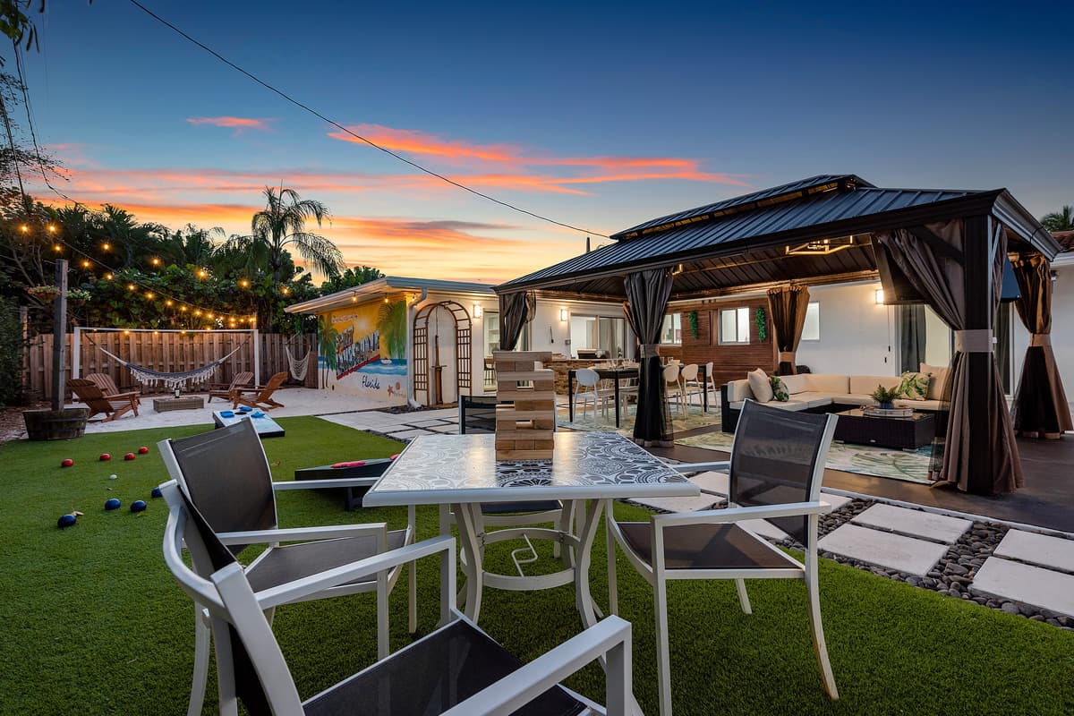 Full backyard view — games, dining, lounging, and tropical vibes.