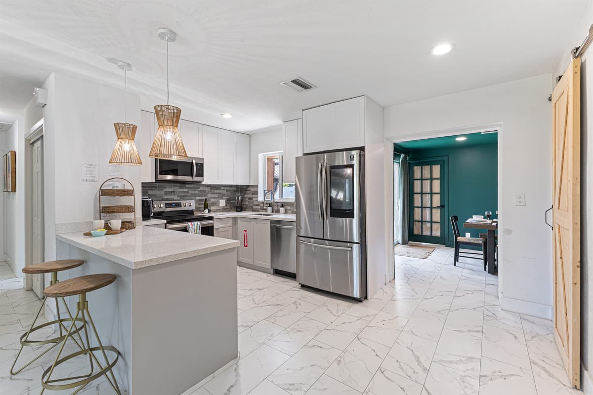 Fully equipped kitchen — stainless appliances, Keurig, and filtered water.